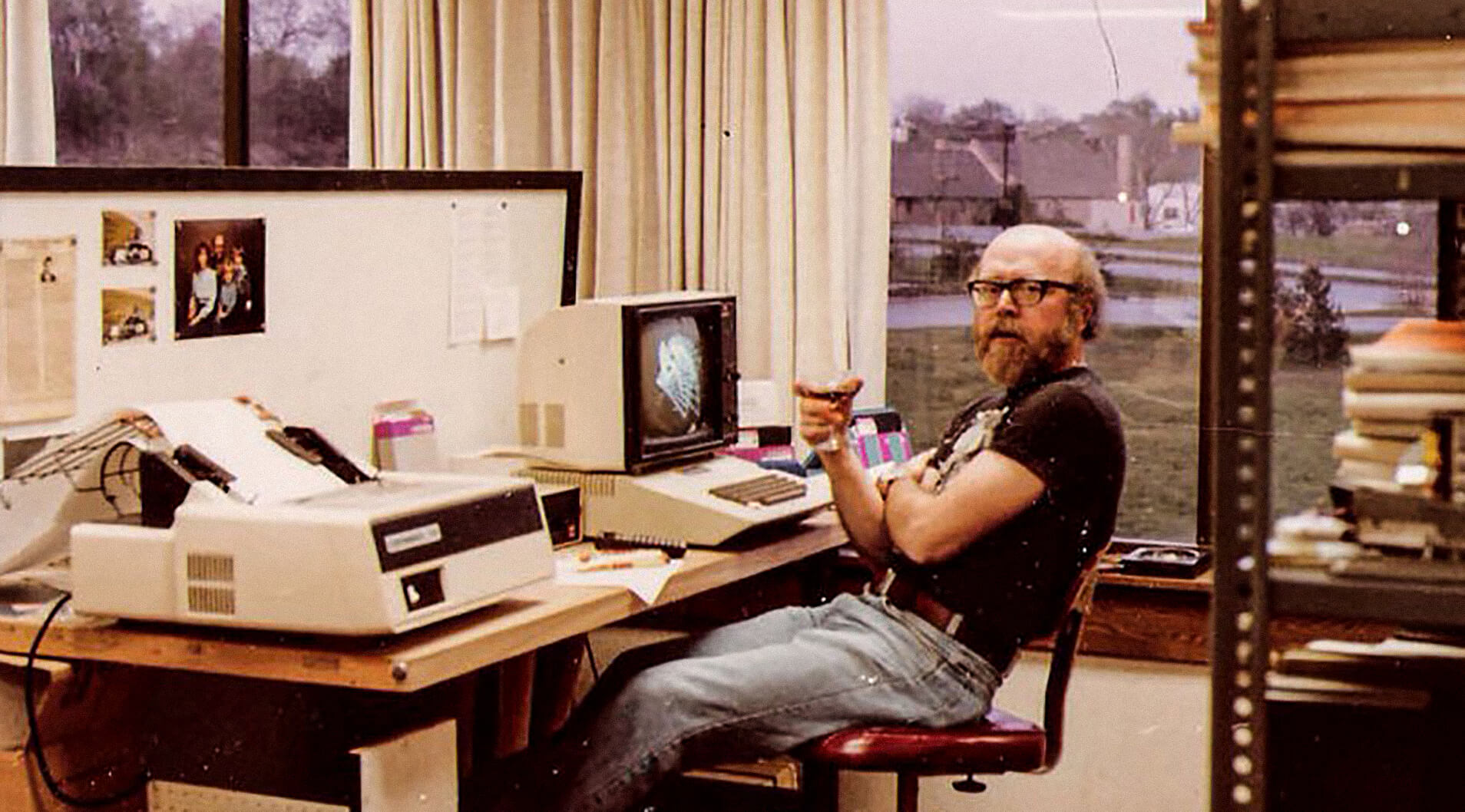 Fran Henderson sitting at his desk working from the 1970's.