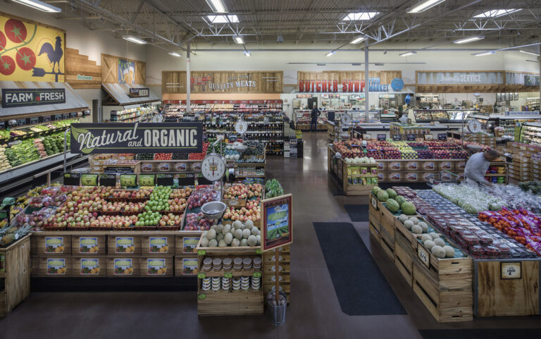 People shop inside the produce section of Sprouts Farmers Market.