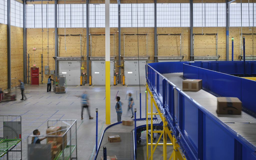 Packages move along a conveyor belt in Amazon's DII5 Delivery Station.