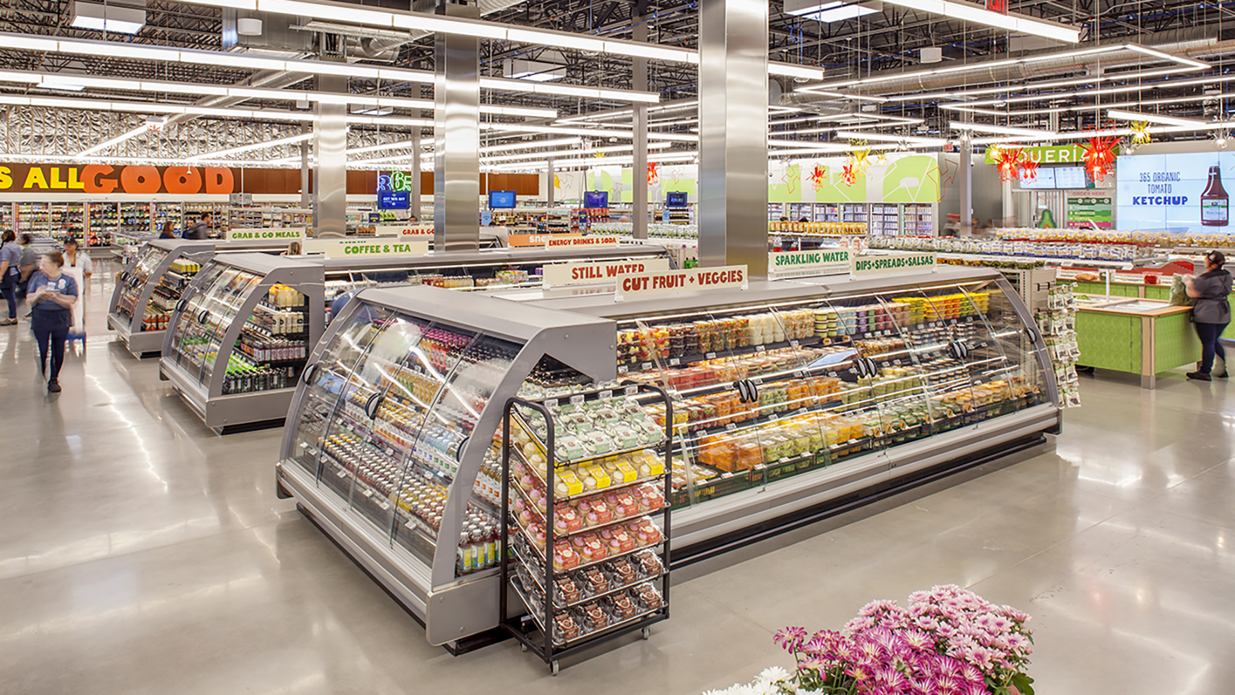 Photo of the interior of a refrigerated produce section in a grocery store.