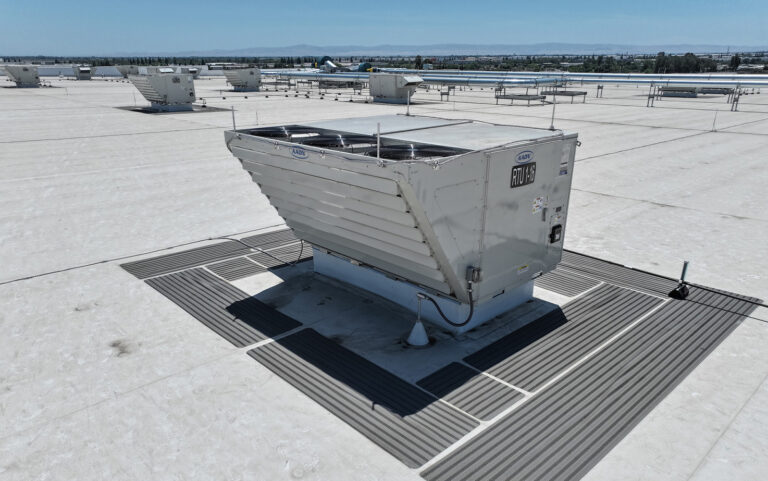 A rooftop unit (RTU) on top of a large-scale industrial warehouse and distribution center.