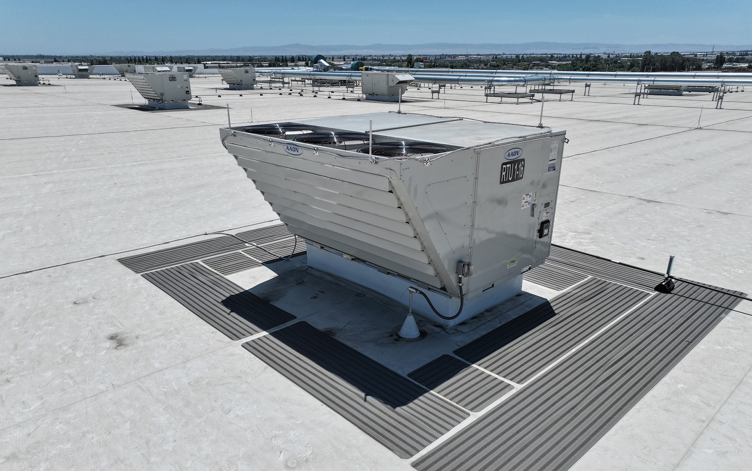 A rooftop unit (RTU) on top of a large-scale industrial warehouse and distribution center.